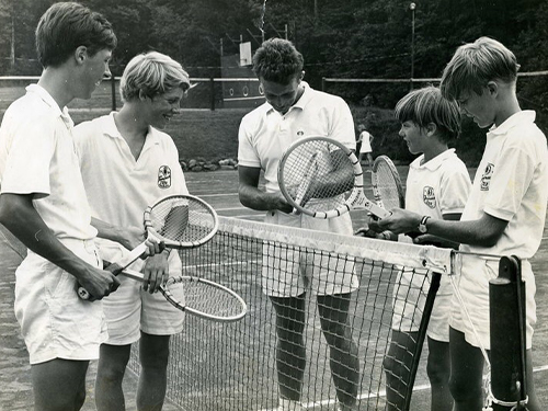 Group Of Campers Playing Tennis